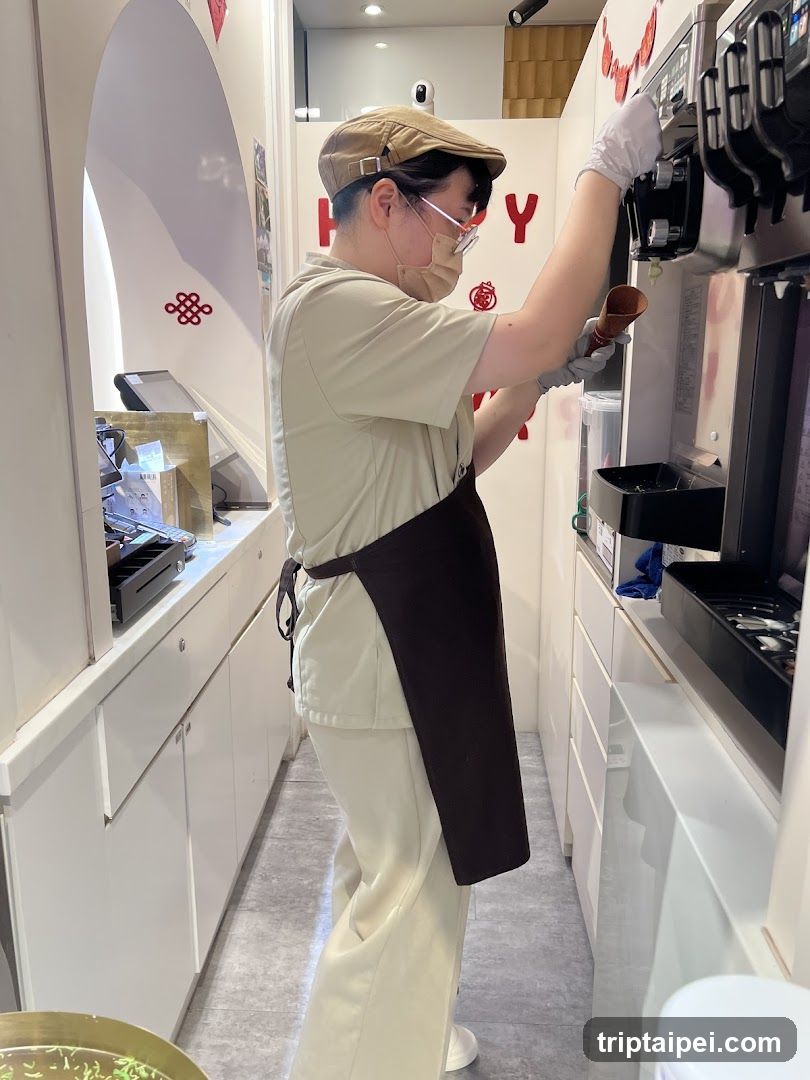 Staff preparing soft serve in a modern ice cream shop