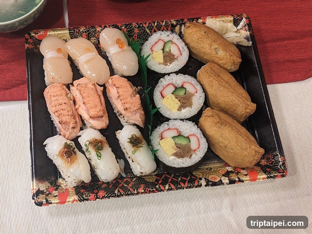 A black rectangular tray with floral pattern holds an assortment of Japanese sushi. On the left, there are six pieces of nigiri: three topped with white fish (likely sea bream or flounder), two with grilled salmon, and one with eel sauce. In the center, four maki rolls feature crab stick, avocado, and tamagoyaki. On the right, three golden-brown fried items resembling tempura or fried tofu are arranged alongside a small garnish of pickled ginger.