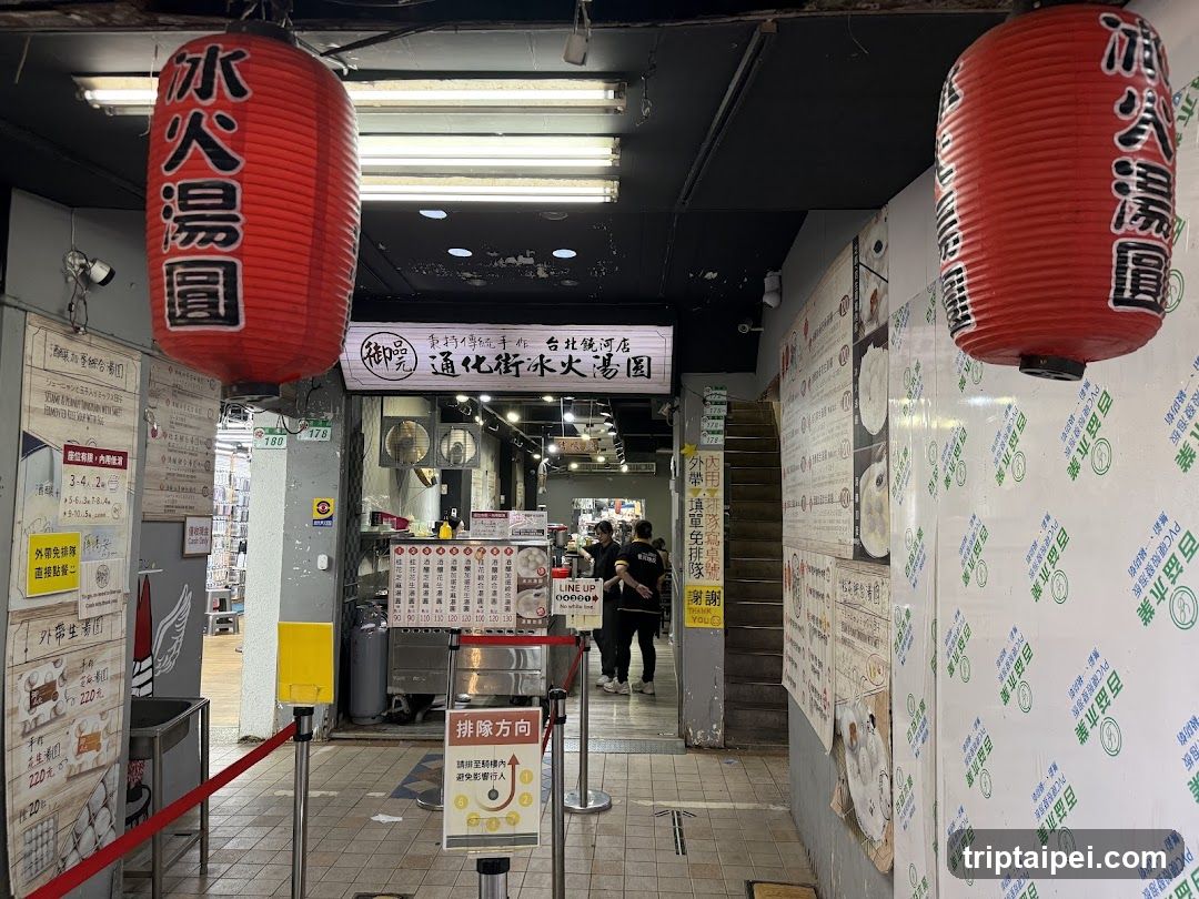 Entrance to a noodle shop with red lanterns and menu boards