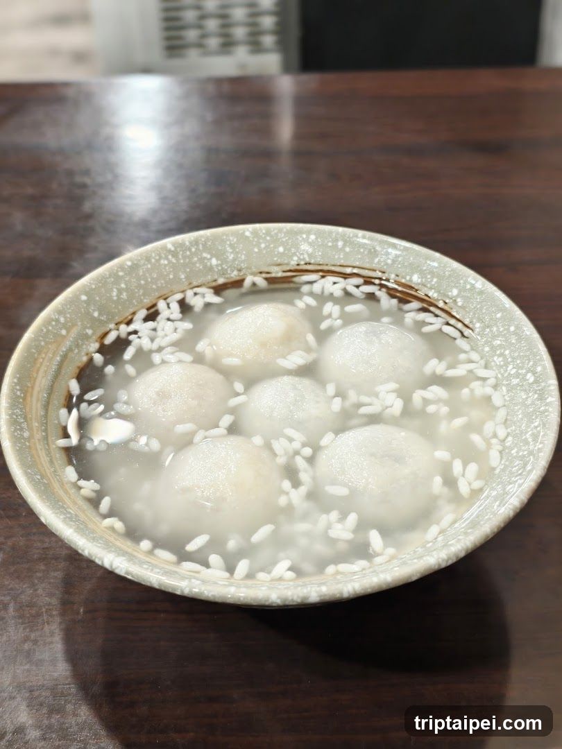 Bowl of Rice Balls in Broth with Sesame Seeds