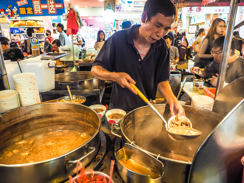 Chen Dong serving medicinal pork rib soup from large vats at Raohe Night Market