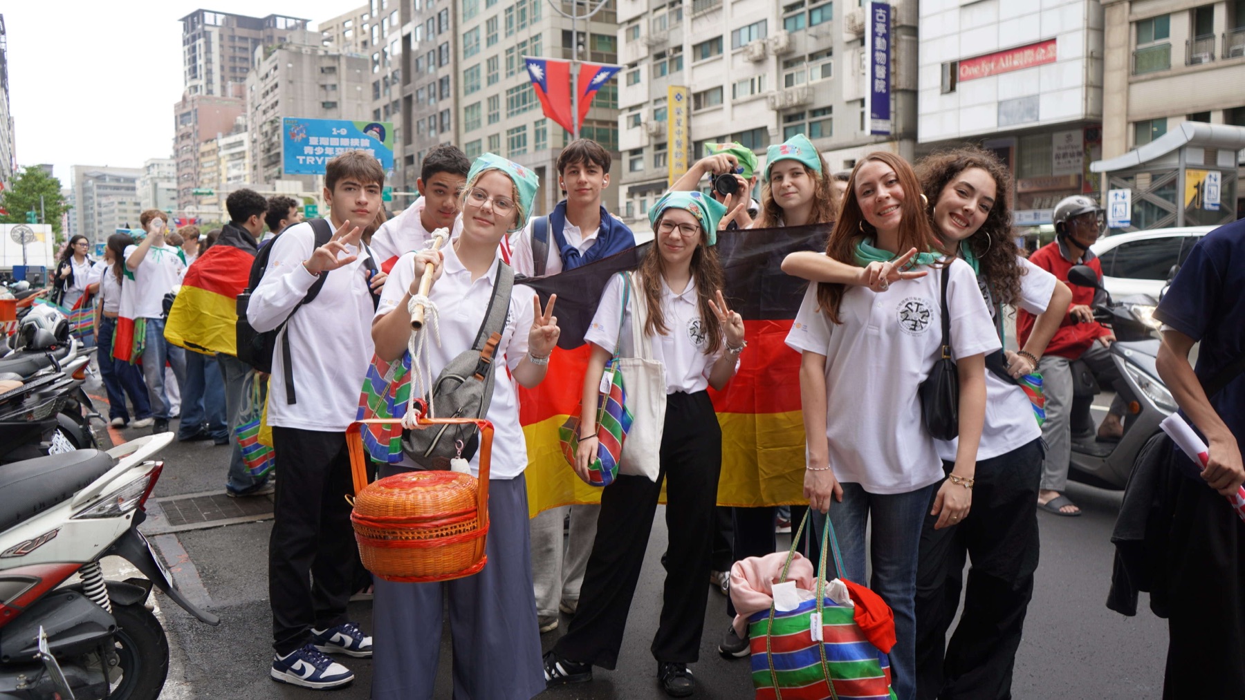 International students in the 挑擔 parade carrying Hakka baskets on a Taipei street