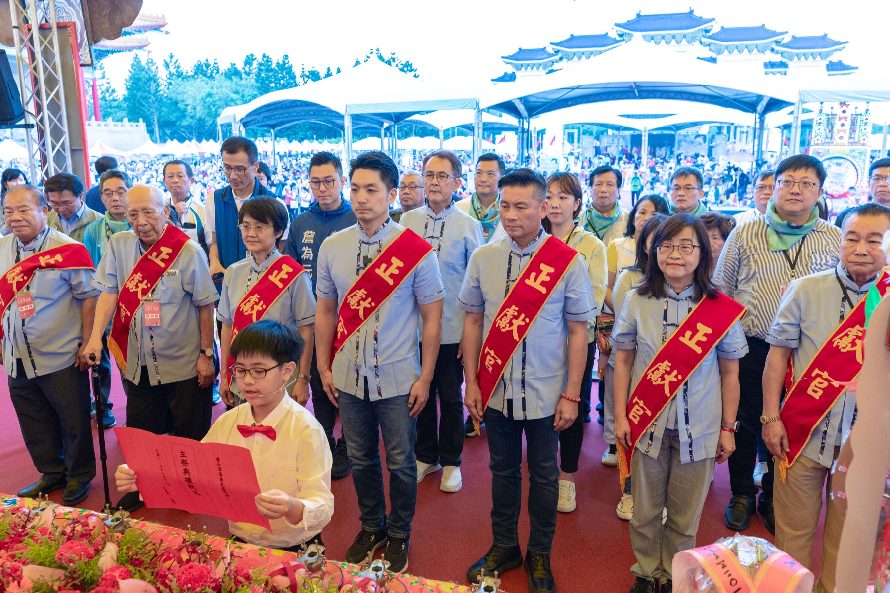 Offering officials in red sashes at the main Yimin rite on Liberty Square, Chiang Kai-shek Memorial Hall behind the tents